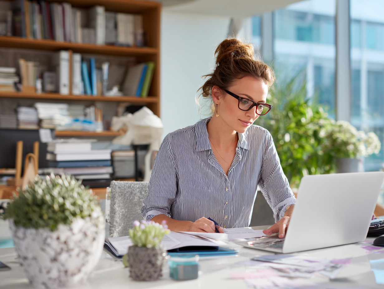 accountant happily working in a neat office due to her workflow software.
