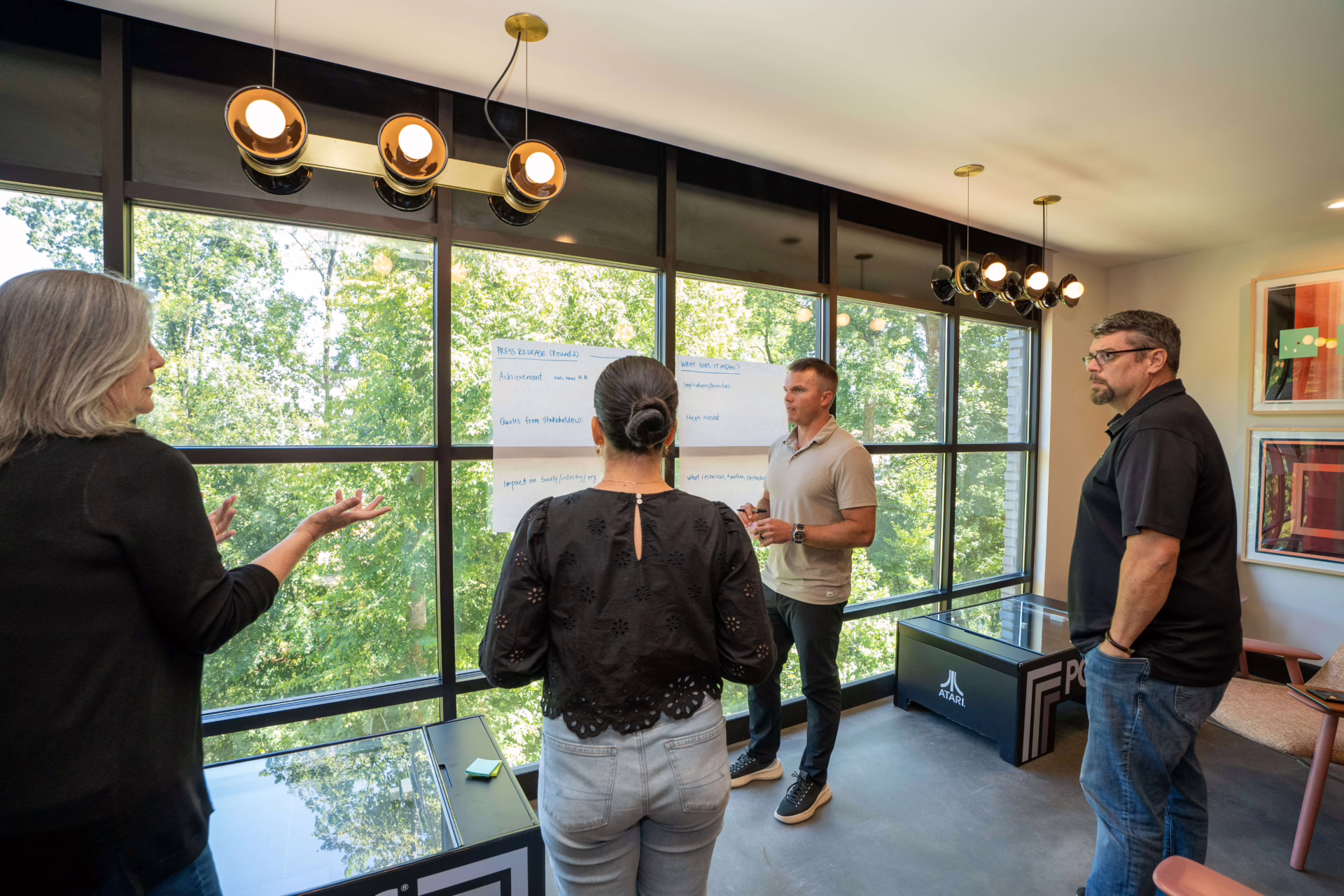 Firm360 team gathered in a relaxed, collaborative workspace for a SaaS company meeting