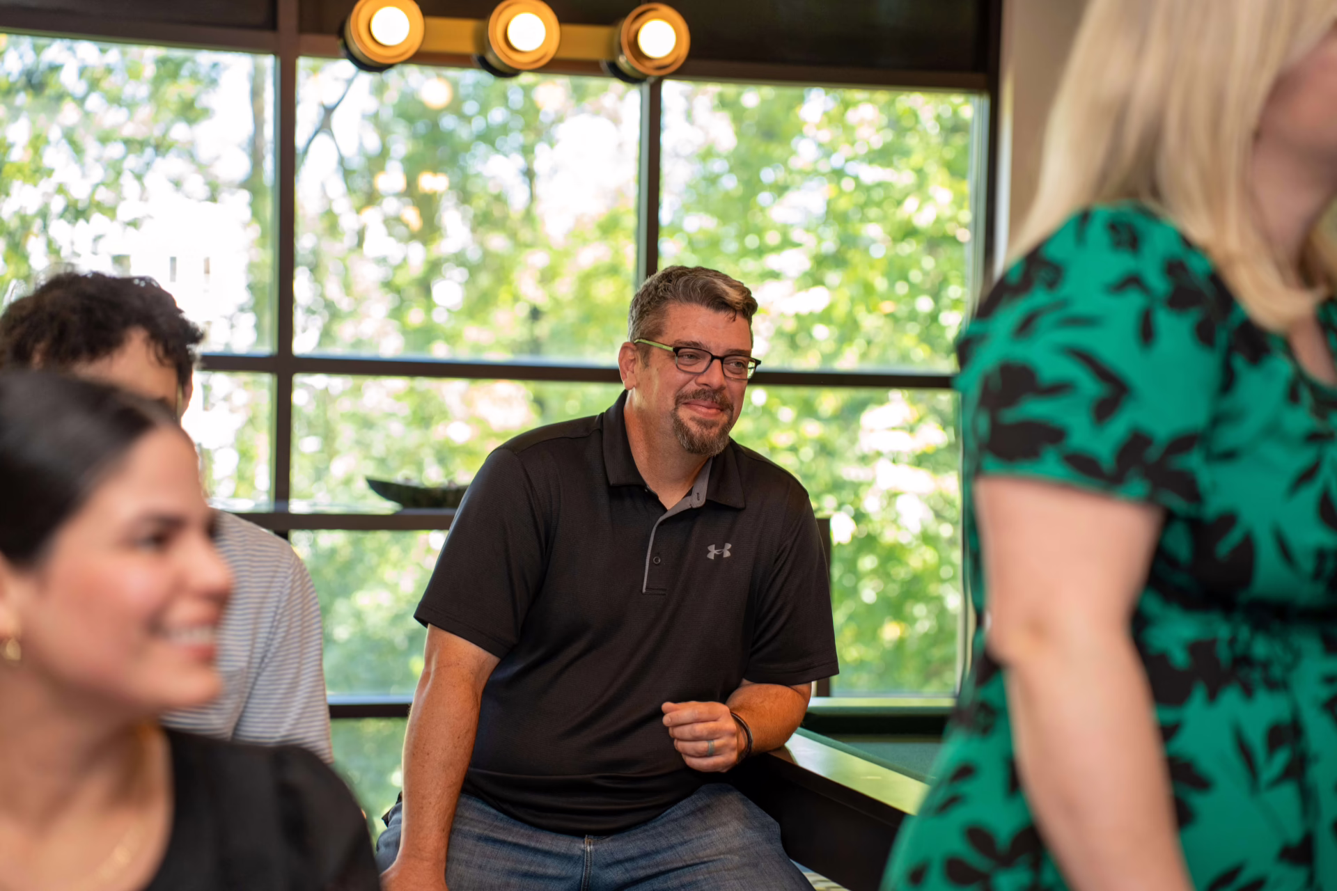 Firm360 team gathered in a relaxed, collaborative workspace for a SaaS company meeting