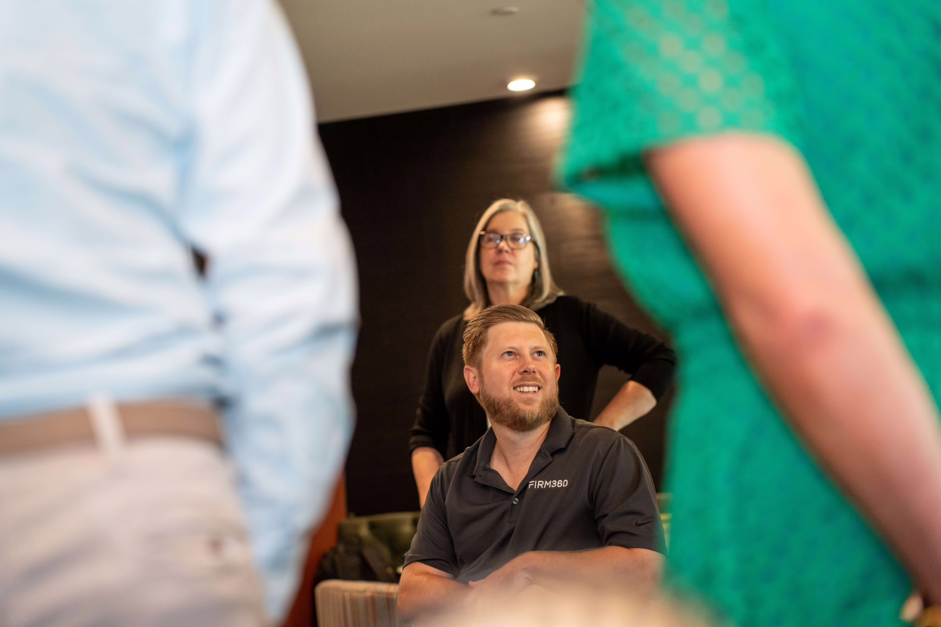 Firm360 team gathered in a relaxed, collaborative workspace for a SaaS company meeting