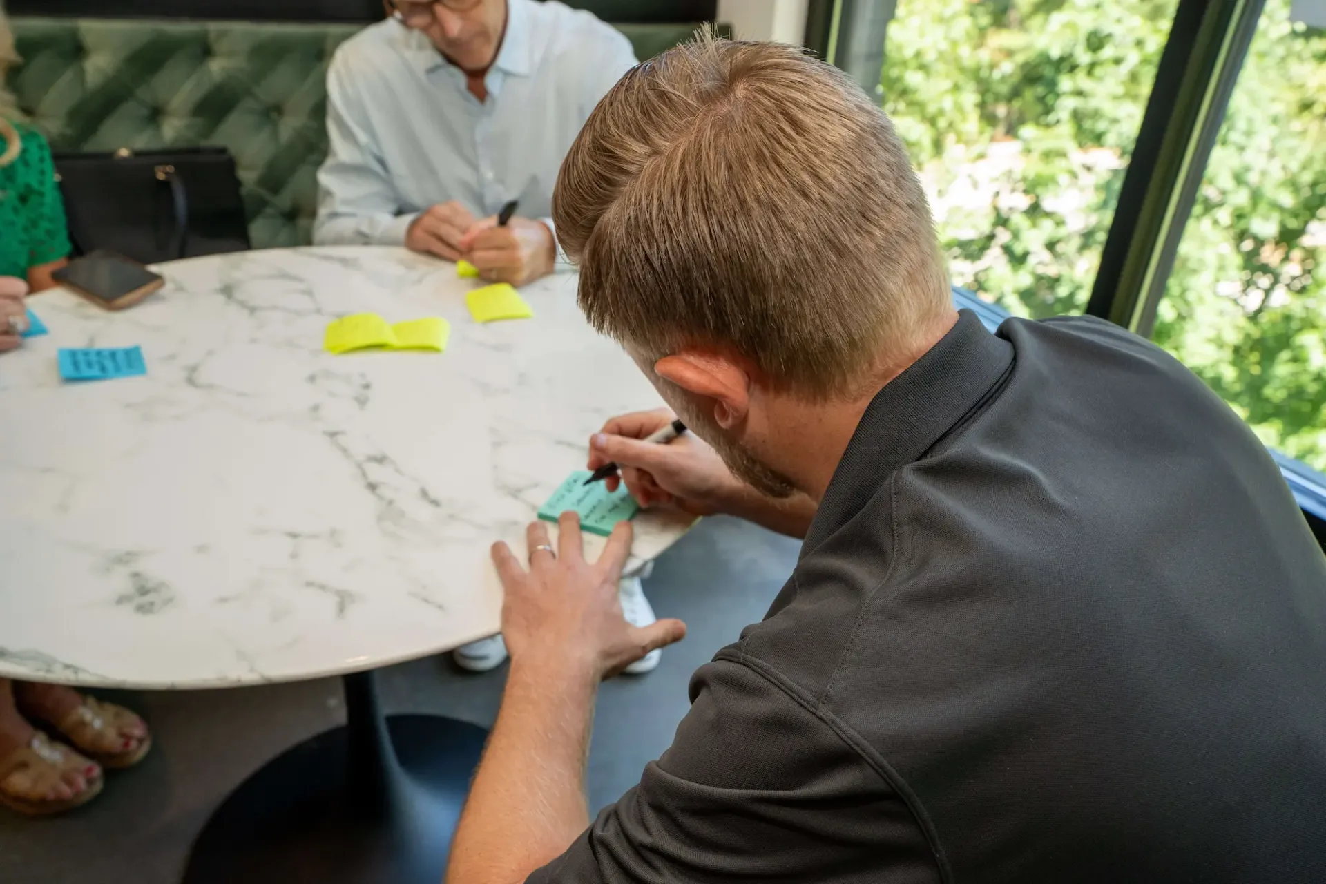 Firm360 team gathered in a relaxed, collaborative workspace for a SaaS company meeting