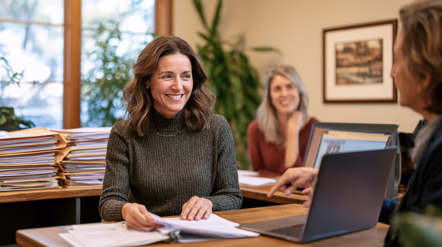 Tax firm staff reviewing client documents together in an office